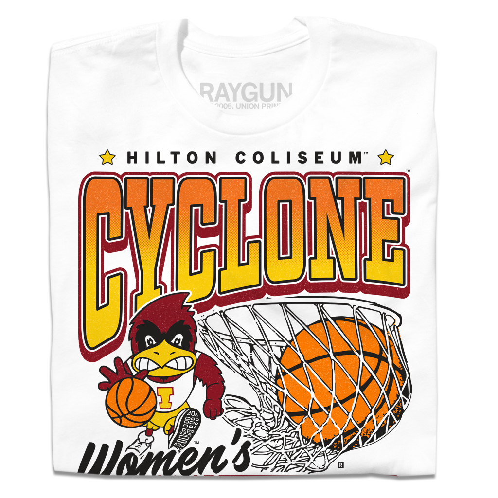 A folded white t-shirt with black, red, orange, and gold ink. From top to bottom it reads "Hilton Coliseum. Cyclone Women's Basketball. Established 1973." With an illustration of Cy dribbling a basketball beside a giant basketball going through a hoop.