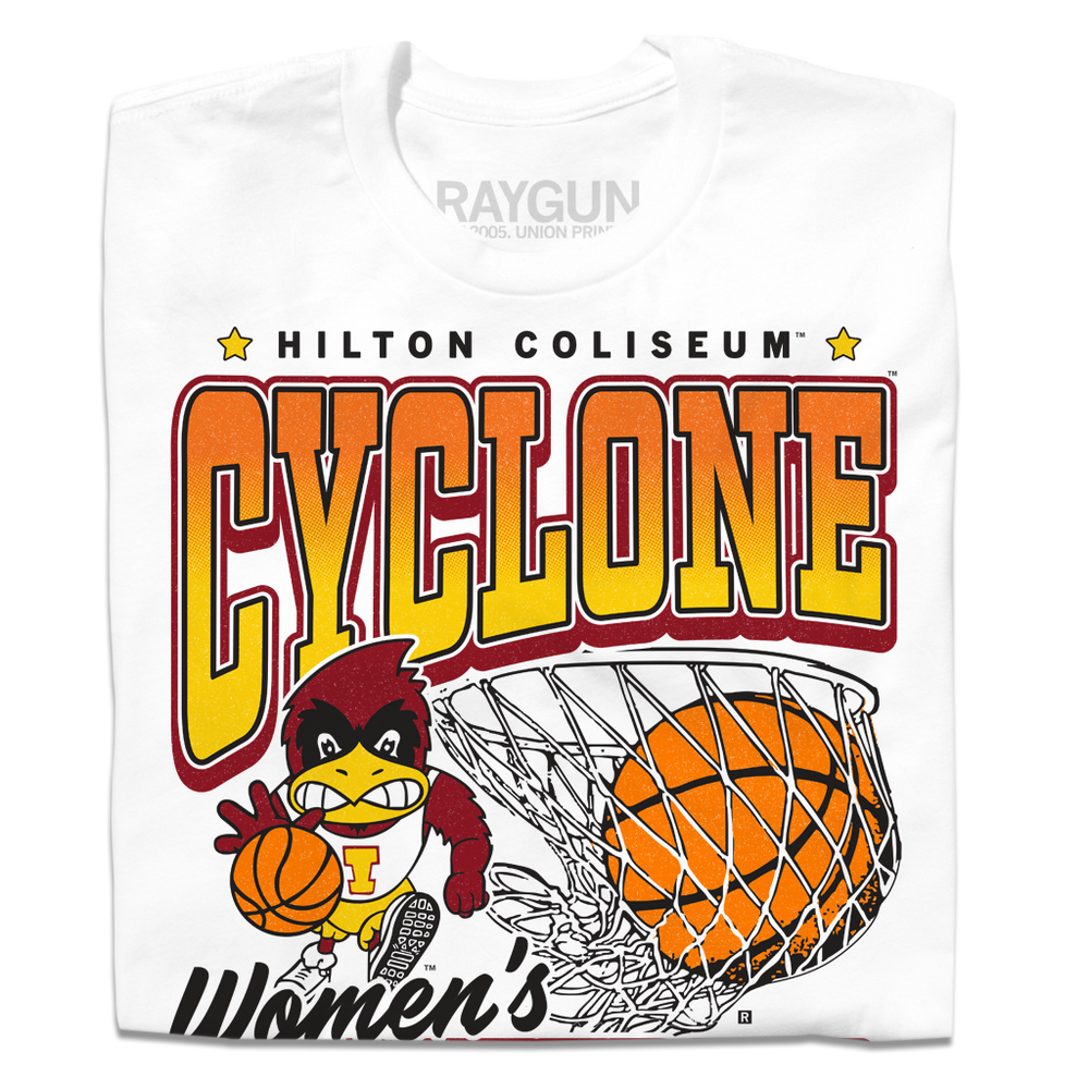 A folded white t-shirt with black, red, orange, and gold ink. From top to bottom it reads "Hilton Coliseum. Cyclone Women's Basketball. Established 1973." With an illustration of Cy dribbling a basketball beside a giant basketball going through a hoop.