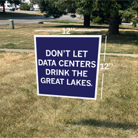 A square dark blue yard sign with a white border and white text that reads "Don't Let Data Centers Drink The Great Lakes" shown on a lawn.