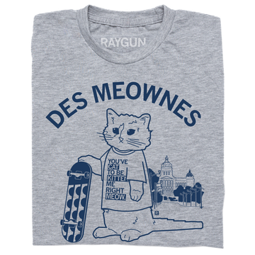 Heather gray t-shirt featuring an illustration of a cat holding a skateboard in front of a capitol building, with the text DES MEOWNES and the cat’s shirt reading YOUVE CAT TO BE KITTEN ME RIGHT MEOW.