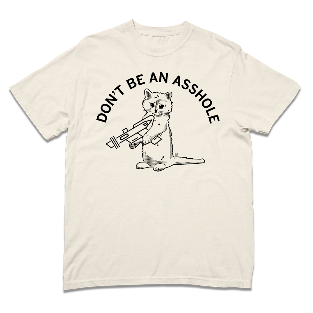 Comfort Colors ivory heavyweight t-shirt with curved black text that says, "DON'T BE AN ASSHOLE" above an illustration of a cat holding a raygun.