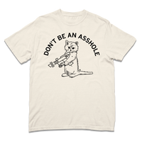 Comfort Colors ivory heavyweight t-shirt with curved black text that says, "DON'T BE AN ASSHOLE" above an illustration of a cat holding a raygun.