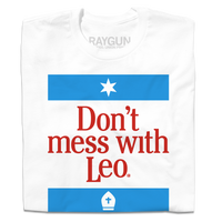 A folded white t-shirt with blue and red ink lade out like a blend of the Texas and Chicago flag that says, "Don't mess with Pope Leo."