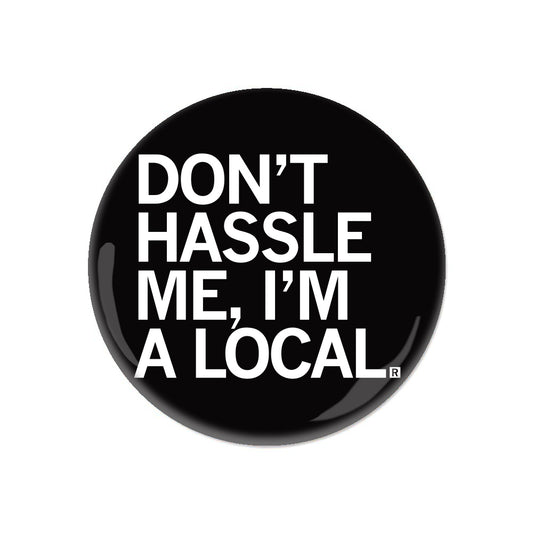 Black circular RAYGUN pinback button with white text that reads, DONT HASSLE ME, IM A LOCAL.