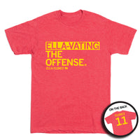 Short sleeve heather red t-shirt with left aligned yellow print text that reads "ELLA-VATING THE OFFENSE" with smaller print below that says, "ELLA FLOREZ" with a tiny outline of Iowa to the right that has "11" in it. A circular picture in the bottom right shows the back of the shirt. The back is printed like a jersey with "FLOREZ" at the top above a large "11."
