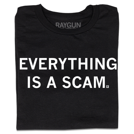 A folded black t-shirt with centered white ink text that says, "Everything is a scam."