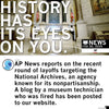 The National Archives rotunda features the text HISTORY HAS ITS EYES ON YOU. Below, an AP News graphic reports on agency layoffs alongside a former technician’s blog post, all displayed on a charcoal t-shirt.