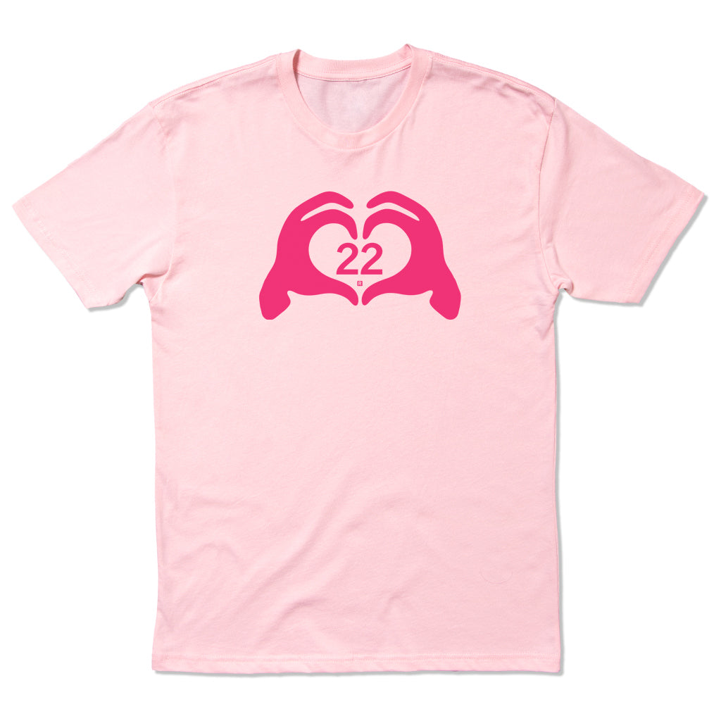 Light pink RAYGUN t-shirt featuring a dark pink graphic of two hands forming a heart shape with the number 22 in the center.