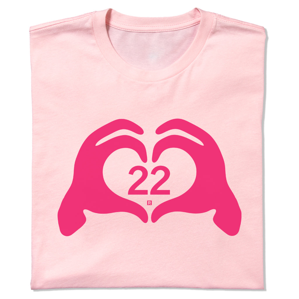 Neon pink RAYGUN T-shirt featuring a dark pink graphic of hands forming a heart shape around the number 22.