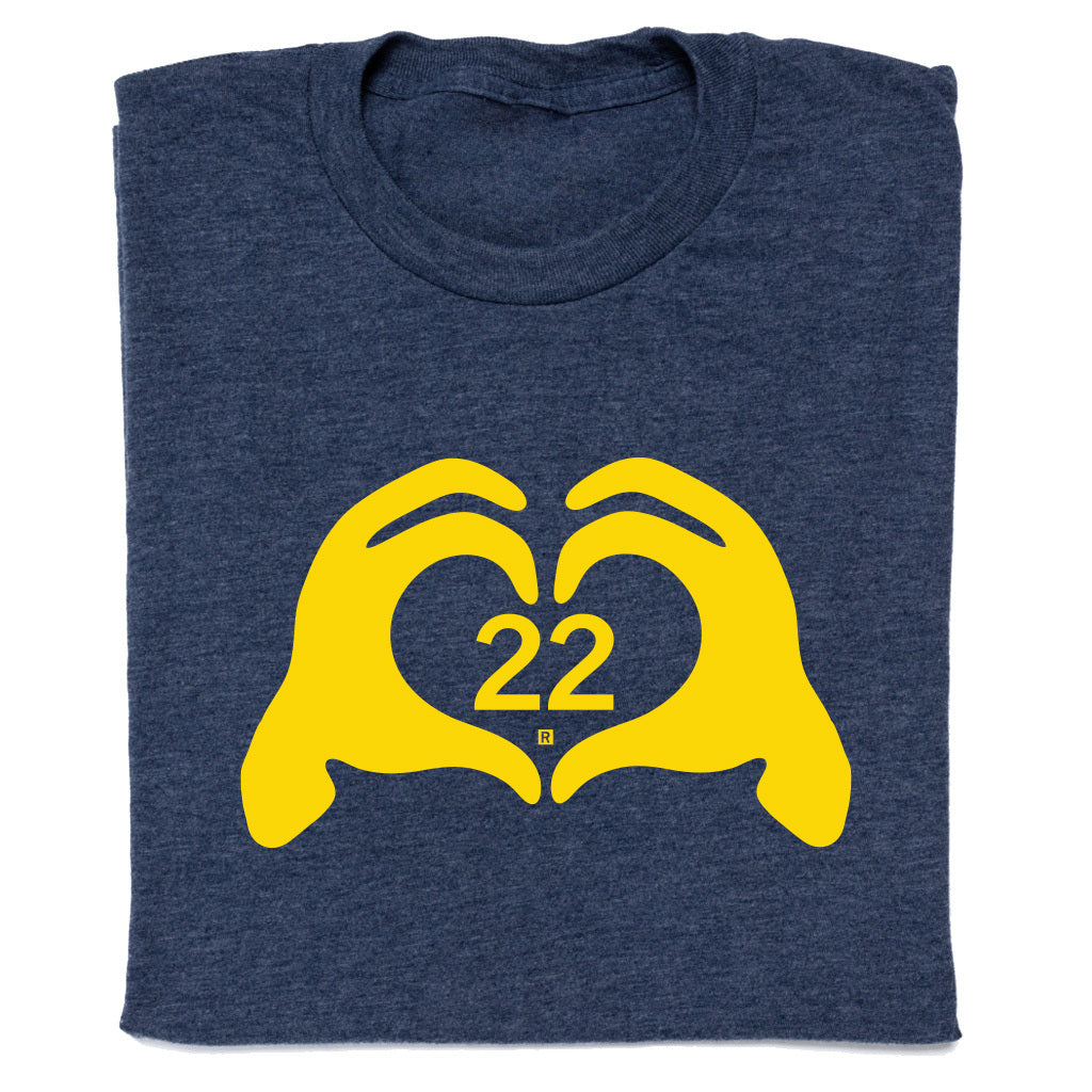 Navy blue RAYGUN t-shirt with a yellow graphic of two hands forming a heart shape around the number 22.