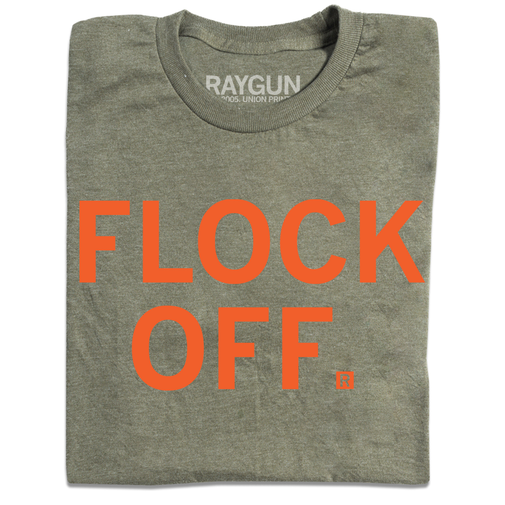 A folded heather military green t-shirt with centered orange ink in all caps that says, "Flock Off."