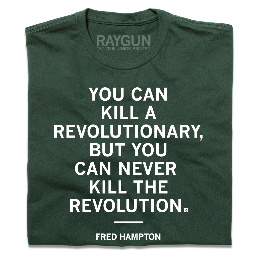Forest green T-shirt printed with the white text YOU CAN KILL A REVOLUTIONARY, BUT YOU CAN NEVER KILL THE REVOLUTION and FRED HAMPTON on the chest. This Made in USA garment is constructed with union labor.