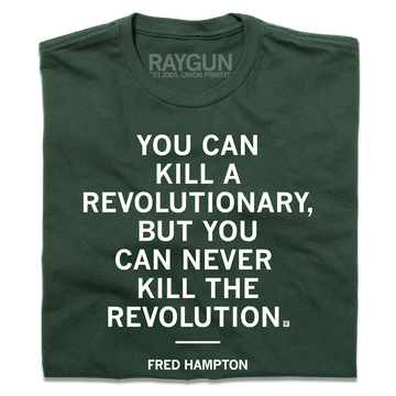 Forest green T-shirt printed with the white text YOU CAN KILL A REVOLUTIONARY, BUT YOU CAN NEVER KILL THE REVOLUTION and FRED HAMPTON on the chest. This Made in USA garment is constructed with union labor.