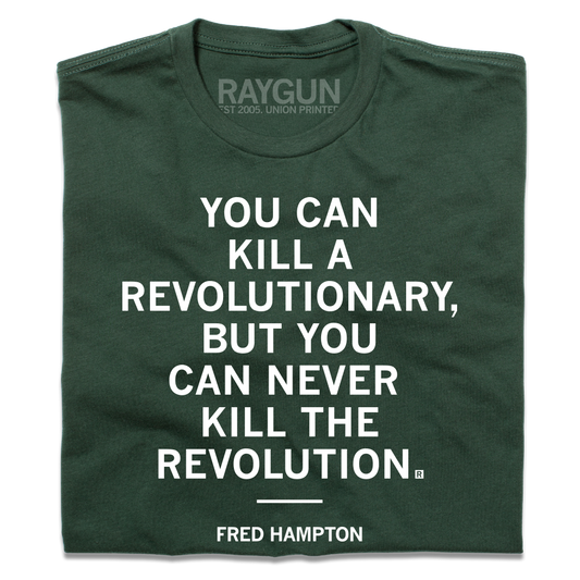 Forest green T-shirt printed with the white text YOU CAN KILL A REVOLUTIONARY, BUT YOU CAN NEVER KILL THE REVOLUTION and FRED HAMPTON on the chest. This Made in USA garment is constructed with union labor.