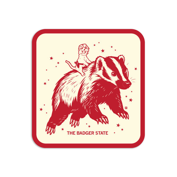 Cream sticker with a red border and red illustration of a cat wearing a cheese hat riding a giant badger above the text 