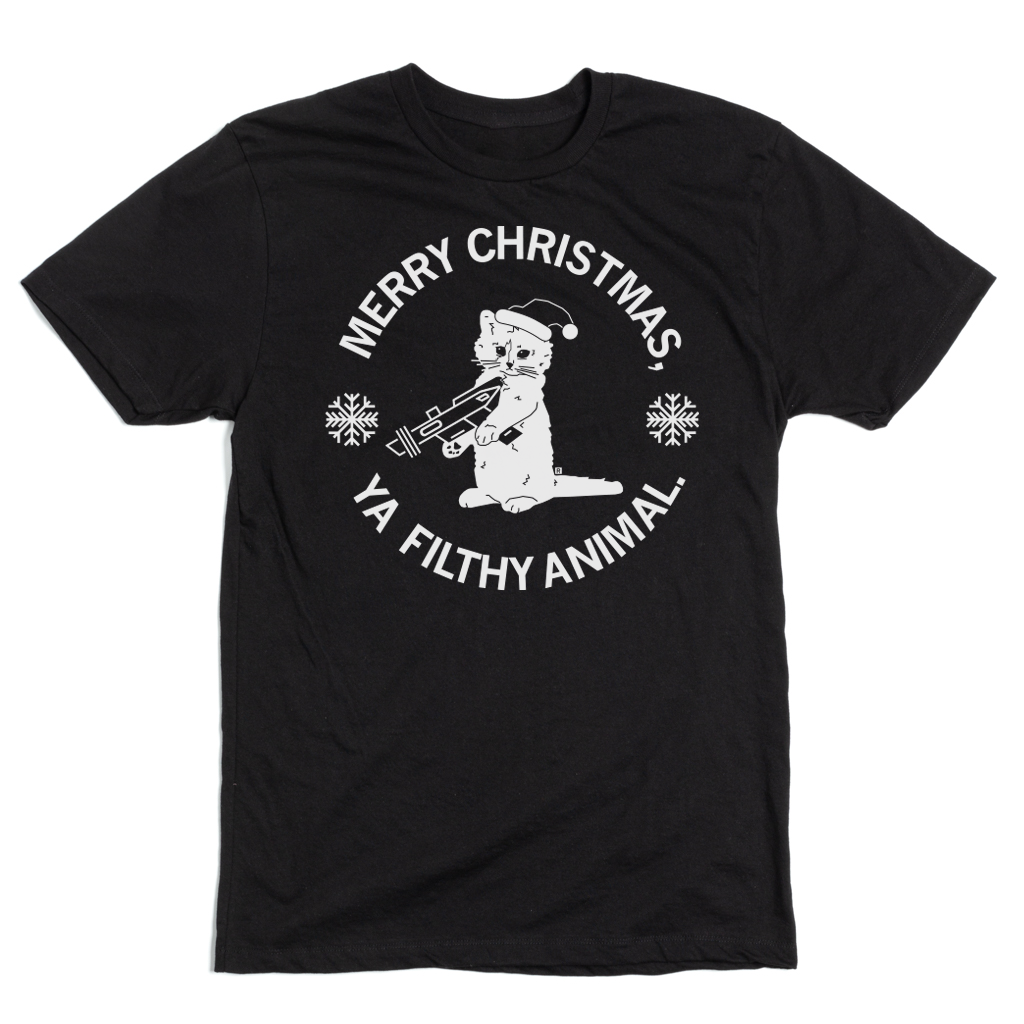 A black t-shirt with white text that reads "Merry Christmas Ya Filthy Animal" around an image of RAYGUN's cat mascot, Gary, holding a raygun while wearing a Santa hat.