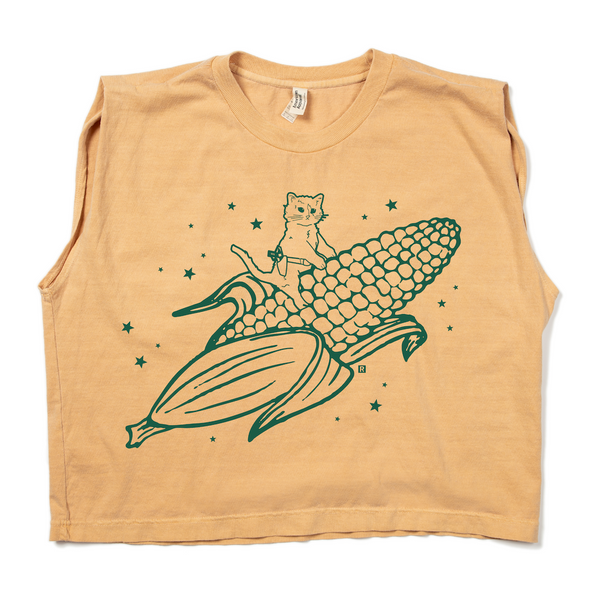 A faded yellow muscle crop top with kelly green ink print depicting RAYGUN's cat mascot riding a giant ear of corn.