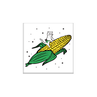 White square magnet with an illustration of a cat with a RAYGUN holstered riding a giant ear of corn through the sky.