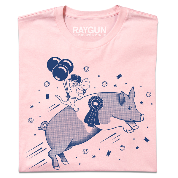 A folded light pink t-shirt with royal blue print depicting a hat with a cowboy hat holding cotton candy while riding a giant pig.