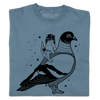 A folded denim blue heavyweight t-shirt with black ink print illustrating RAYGUN's cat mascot riding a giant pigeon.
