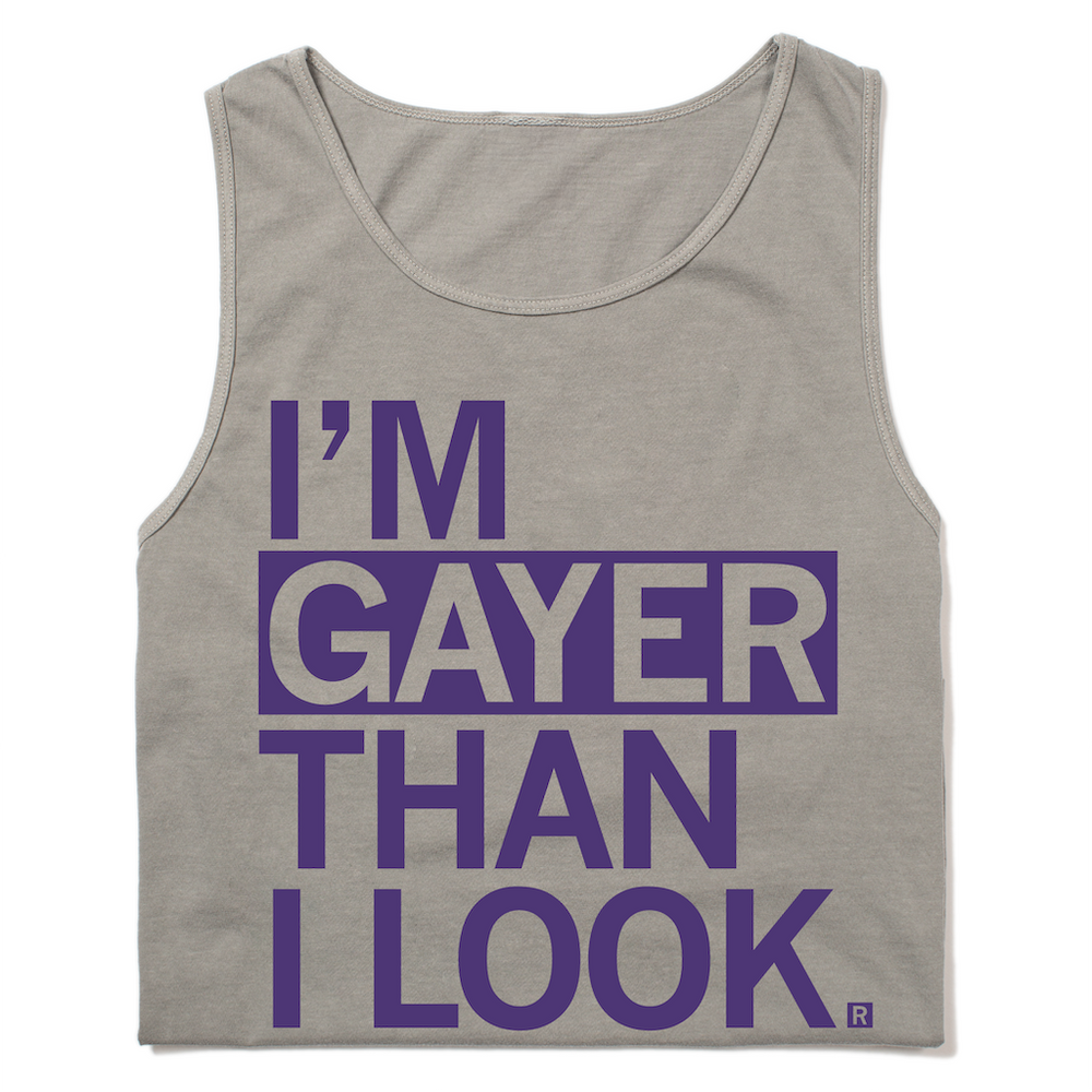 A folded heavyweight grey tank top with purple ink print that reads "I'm gayer than I look."