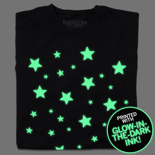 Black RAYGUN t-shirt featuring glow-in-the-dark stars and a circular graphic that reads, Printed with glow-in-the-dark ink!.