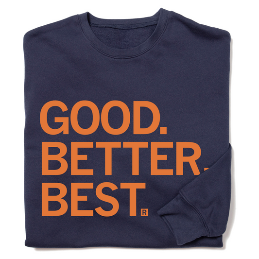 Folded navy sweatshirt with orange ink that reads "Good. Better. Best."