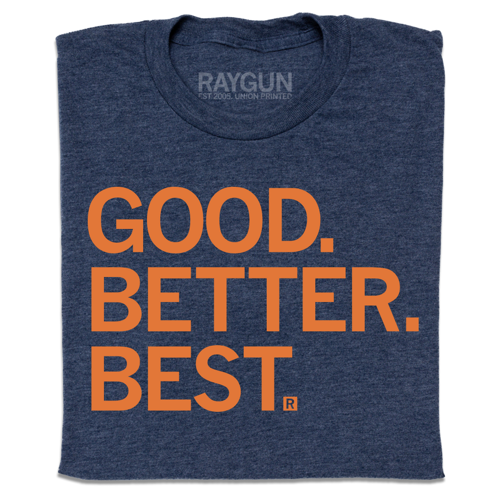 Folded heather navy t-shirt with orange ink that reads "Good. Better. Best."