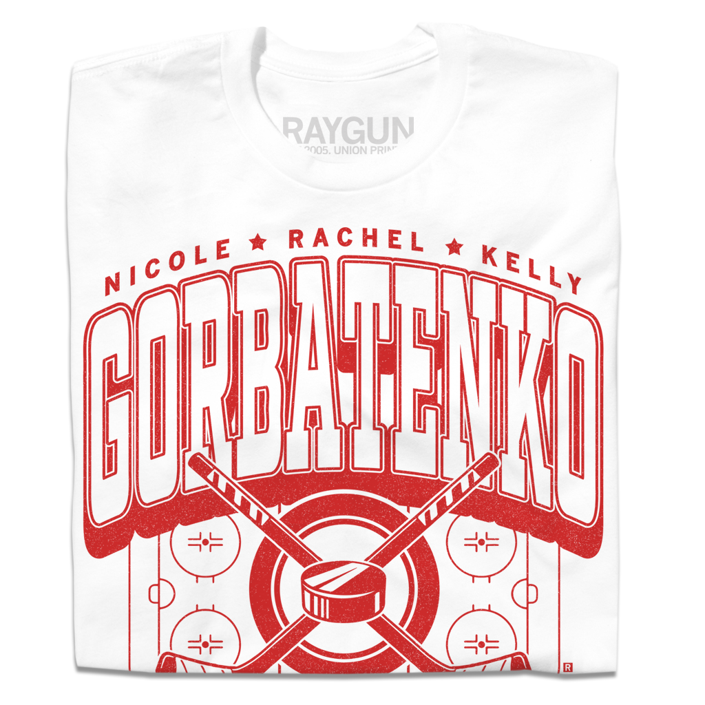 A folded white t-shirt with bright red text that reads, "The Gorbatenko Sisers: Nicole, Rachel, and Kelly from Barrington, IL" along with an illustration of a hockey rink and two crossed hockey sticks