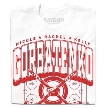 A folded white t-shirt with bright red text that reads, "The Gorbatenko Sisers: Nicole, Rachel, and Kelly from Barrington, IL" along with an illustration of a hockey rink and two crossed hockey sticks