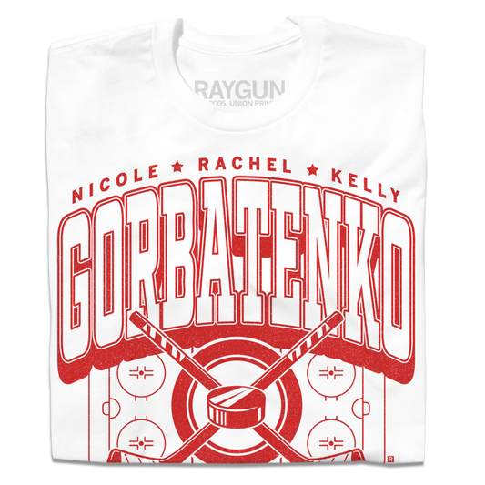 A folded white t-shirt with bright red text that reads, "The Gorbatenko Sisers: Nicole, Rachel, and Kelly from Barrington, IL" along with an illustration of a hockey rink and two crossed hockey sticks