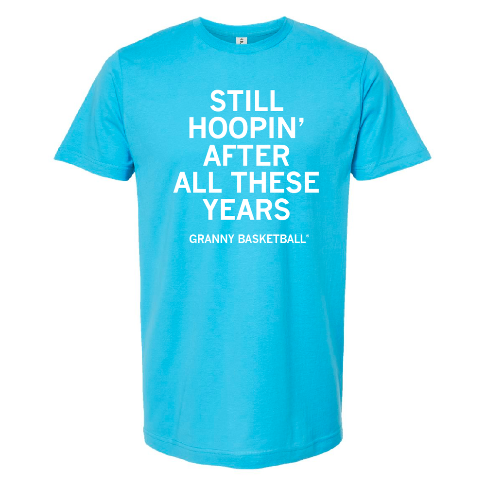 A bright aqua t-shirt with centered white text that says, "Still Hoopin' After All These Years" in large font and smaller text below that says, "Granny Basketball"