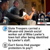 State troopers escort a senior citizen wearing an anti-fascist grandparents t-shirt who is giving a peace sign out of a town hall meeting, while social media commentary claims the individual is a paid protestor.