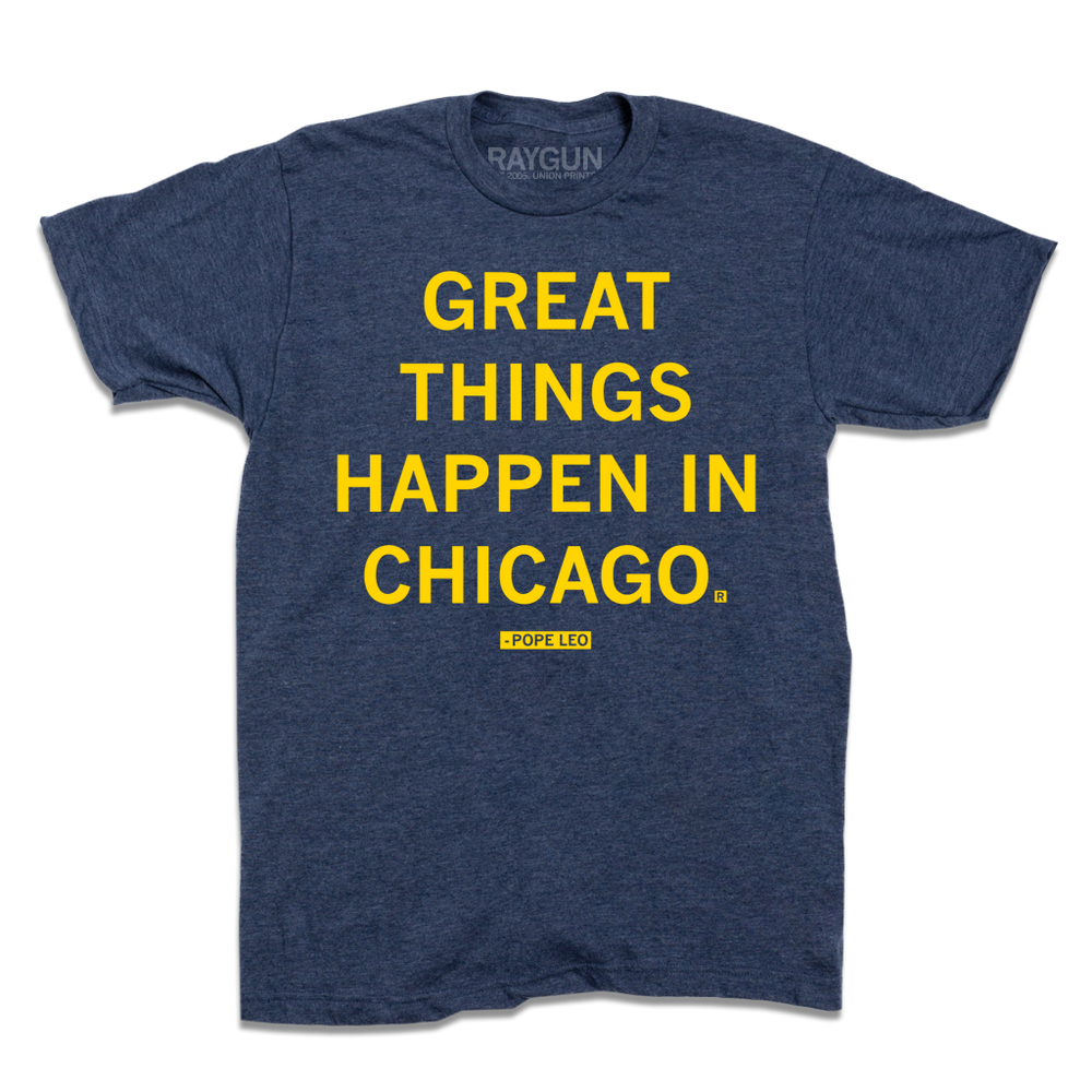 Short-sleeve heather denim shirt with bright yellow text that says, "GREAT THINGS HAPPEN IN CHICAGO" with "-Pope Leo" beneath in smaller text.