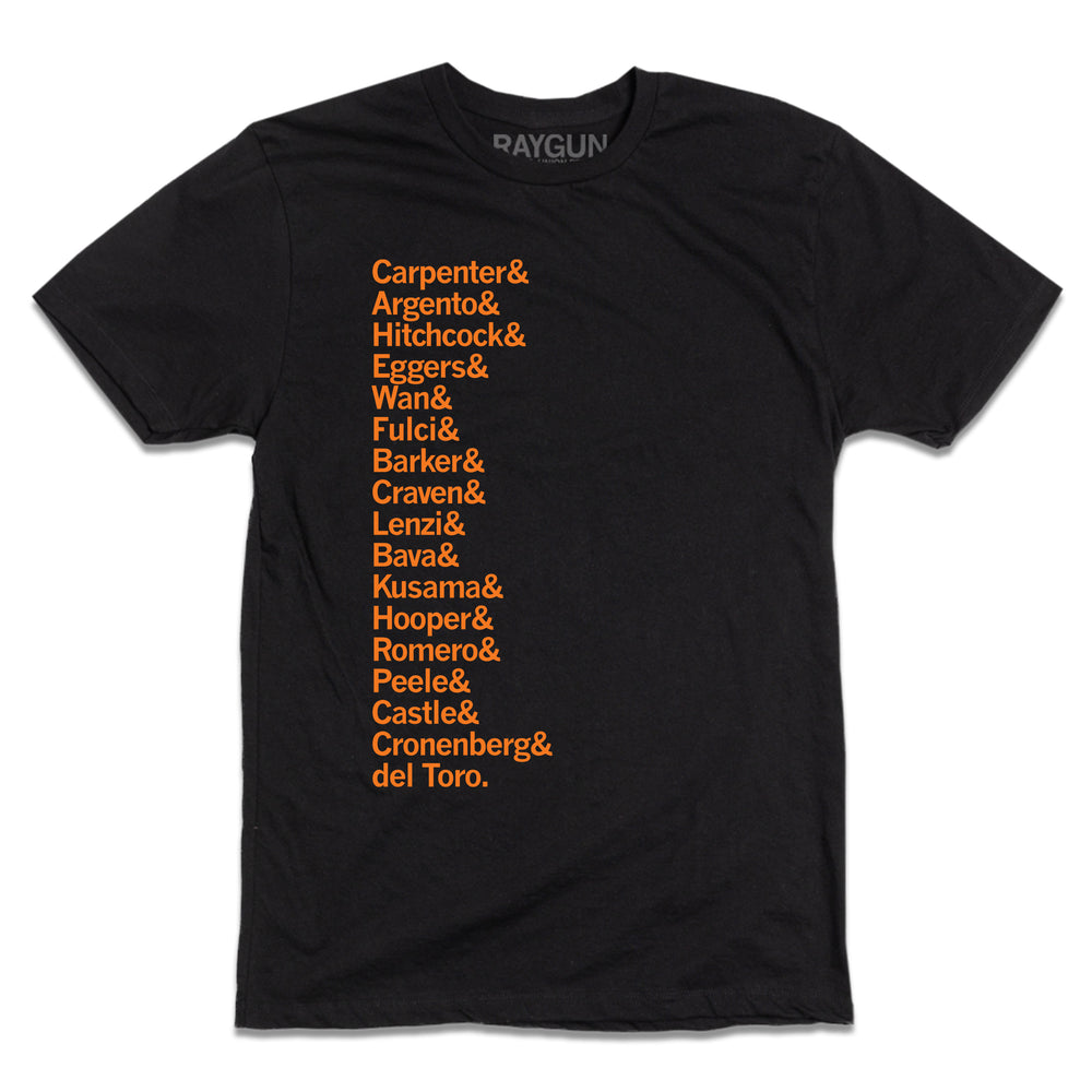 A short-sleeve black t-shirt with left-aligned orange ink in a long list that reads "Carpenter &amp; Argento &amp; Hitchcock &amp; Eggers &amp; Wan &amp; Fulci &amp; Barker &amp; Craven &amp; Lenzi &amp; Bava &amp; Kusama &amp; Hooper &amp; Romero &amp; Peele &amp; Castle &amp; Cronenberg &amp; del Toro."