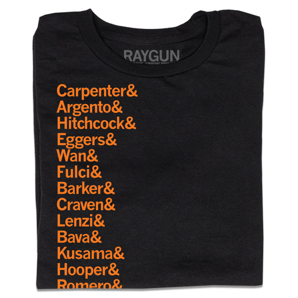 A folded black t-shirt with left-aligned orange ink that says, 