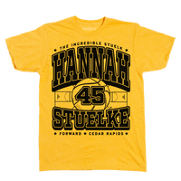 Gold shirt with black print that says, "The Incredible Stuelk. Hannah Stuelke. Forward. Cedar Rapids" over an illustration of a giant basketball and a basketball court.