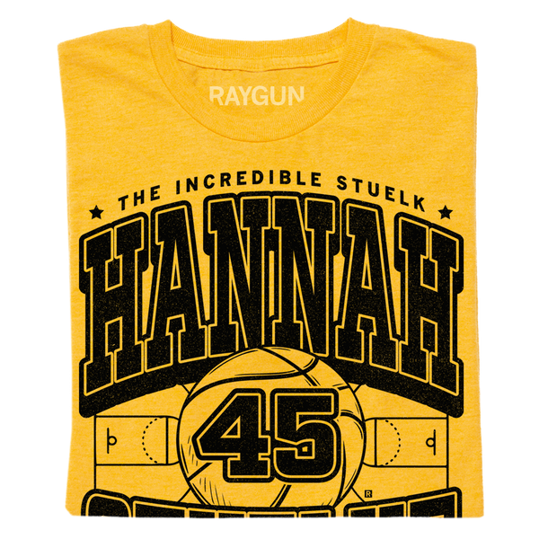 a folded gold shirt with black print that says, 