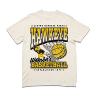 Comfort colors heavyweight ivory t-shirt with Gold & Black ink. From top to bottom it reads "Carver-Hawkeye Arena. Hawkeye Women's Basketball. Established 1974." An illustration of Herky the Hawk beside a basketball in the net are in the center of the shirt.