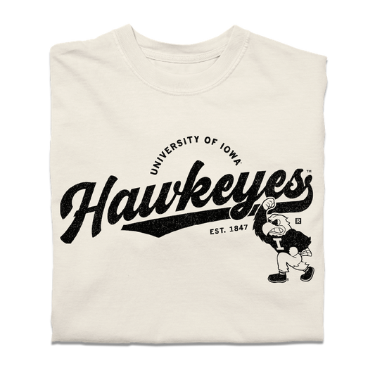 Off-white, heavyweight ivory t-shirt featuring the black text University of Iowa Hawkeyes, Est. 1847, and a cartoon hawk mascot.