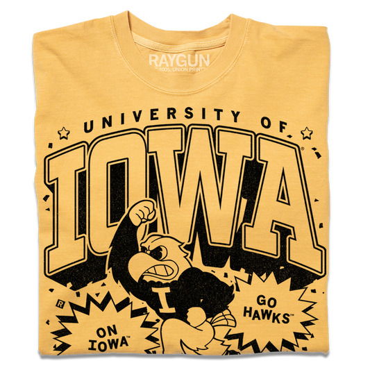 Officially licensed yellow Iowa T-shirt with University of Iowa and Go Hawks printed in black, featuring a graphic of the Iowa Hawkeye mascot raising a fist.