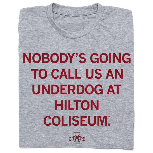 Heather grey t-shirt featuring the text NOBODYS GOING TO CALL US AN UNDERDOG AT HILTON COLISEUM and an Iowa State logo printed in maroon.