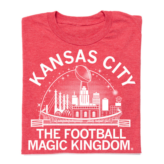 Union-made red t-shirt with a white graphic of the Kansas City skyline, a football, and the text Kansas City The Football Magic Kingdom.