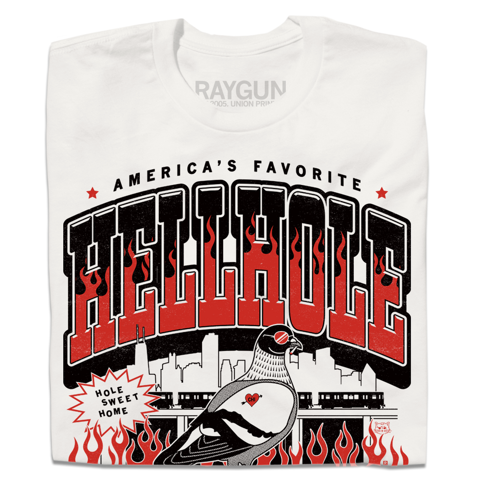 A folded white t-shirt featuring a bold graphic print with the text 'HELLHOLE' in large red and black letters, flames, a pigeon illustration, and the brand name 'RAYGUN' printed inside the collar.