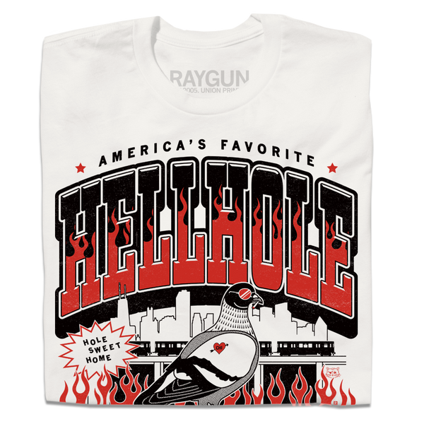 A folded white t-shirt featuring a bold graphic print with the text 'HELLHOLE' in large red and black letters, flames, a pigeon illustration, and the brand name 'RAYGUN' printed inside the collar.