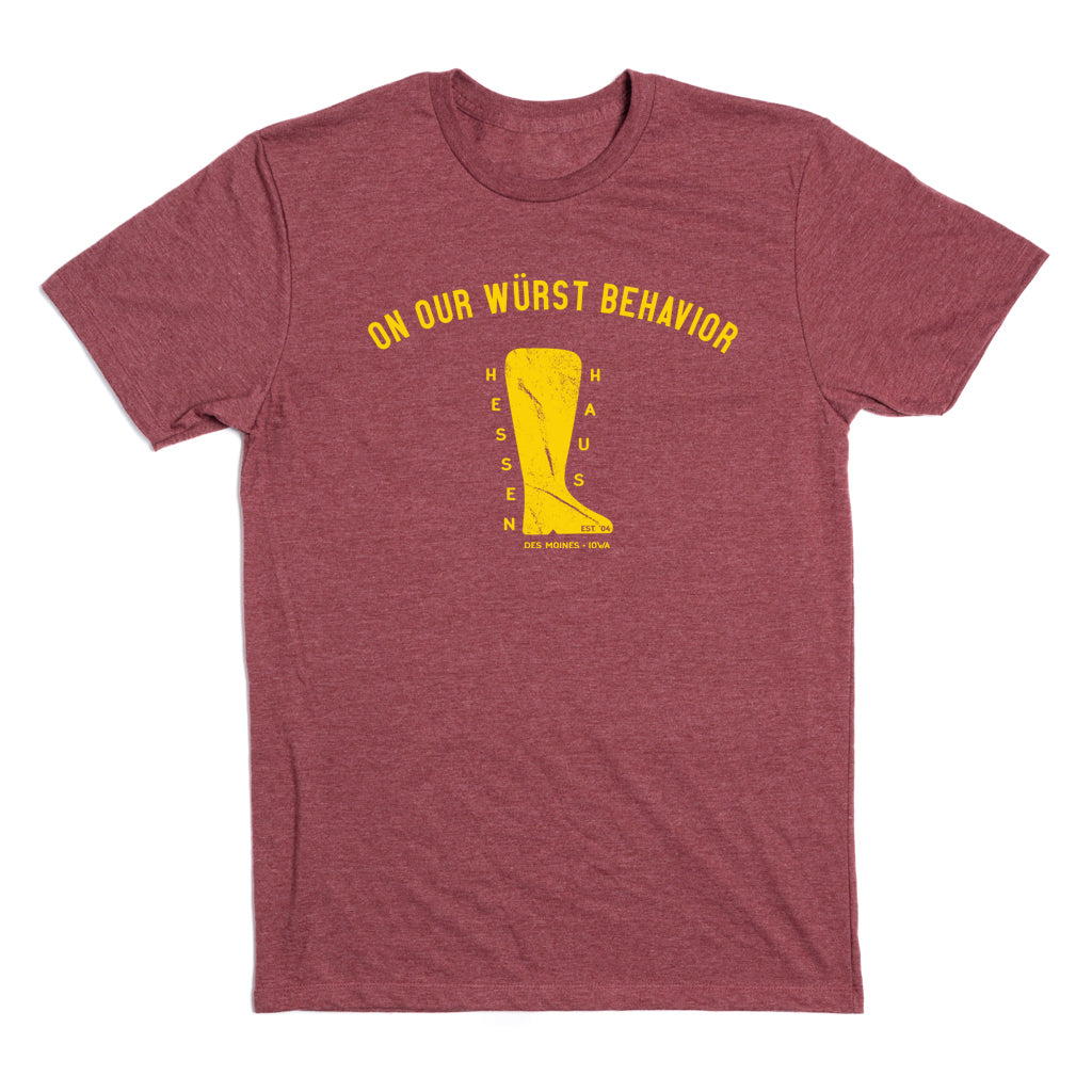 Heather burgundy t-shirt featuring a yellow graphic of a beer boot filled with the text Hessen Haus and the words On our Wurst Behavior above it.