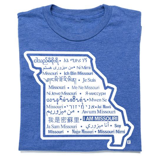 Heather royal blue t-shirt featuring a white outline map of Missouri filled with the phrase I am Missouri translated into many different languages.