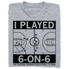 A folded heather grey t-shirt with black ink print depicting a basketball court with text that says, "I played 6-on-6. The original women's basketball in Iowa."