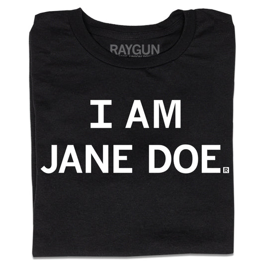 A folded black t-shirt with centered white print text that says, "I Am Jane Doe" in all caps.