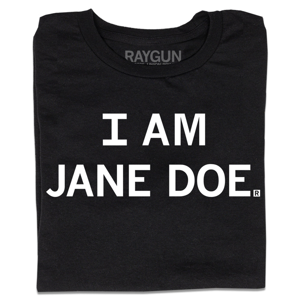 A folded black t-shirt with centered white print text that says, "I Am Jane Doe" in all caps.